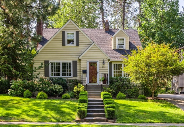 203 W 21st Ave, Spokane, WA 99203 - cape cod home with a chimney, a front yard, and a shingled roof