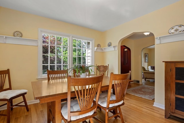 203 W 21st Ave, Spokane, WA 99203 - dining room with arched walkways and light wood-type flooring