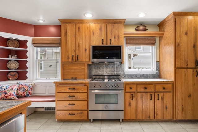 203 W 21st Ave, Spokane, WA 99203 - kitchen with appliances with stainless steel finishes, brown cabinets, backsplash, and light tile patterned floors