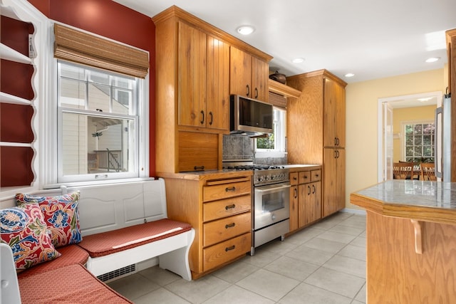 203 W 21st Ave, Spokane, WA 99203 - kitchen with stainless steel appliances, light tile patterned floors, tasteful backsplash, light countertops, and recessed lighting