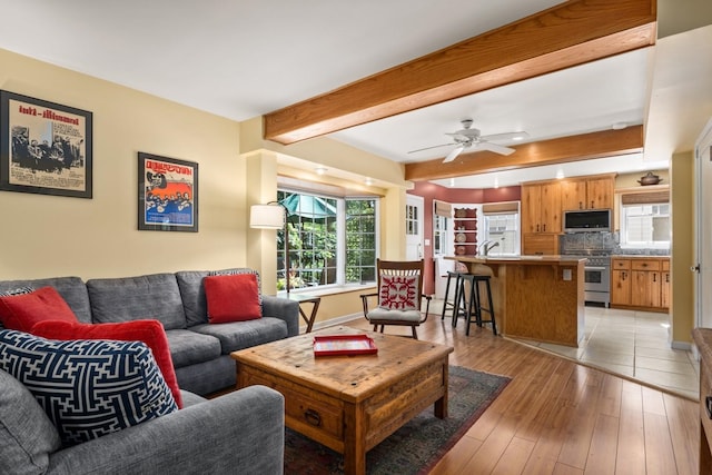 203 W 21st Ave, Spokane, WA 99203 - living room with healthy amount of natural light, beam ceiling, light wood-style floors, and ceiling fan