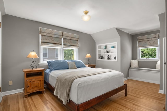 203 W 21st Ave, Spokane, WA 99203 - bedroom with light wood finished floors, multiple windows, and vaulted ceiling