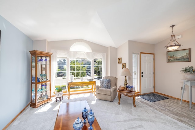 7106 S Moran View St, Spokane, WA 99224 - carpeted living room featuring vaulted ceiling and baseboards