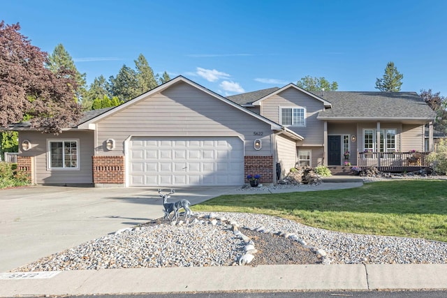 5622 E Sheffield, Colbert, WA 99005 - tri-level home featuring a garage, concrete driveway, a front lawn, and brick siding