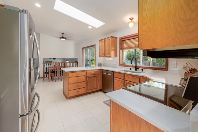 5622 E Sheffield, Colbert, WA 99005 - kitchen with appliances with stainless steel finishes, a peninsula, a skylight, light countertops, and recessed lighting