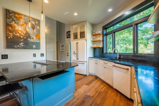 210 3rd St, Dover, ID 83825 - kitchen featuring white appliances, light wood finished floors, white cabinetry, hanging light fixtures, and recessed lighting