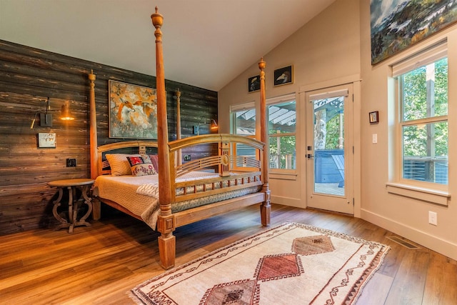 210 3rd St, Dover, ID 83825 - bedroom with access to exterior, wood-type flooring, and high vaulted ceiling