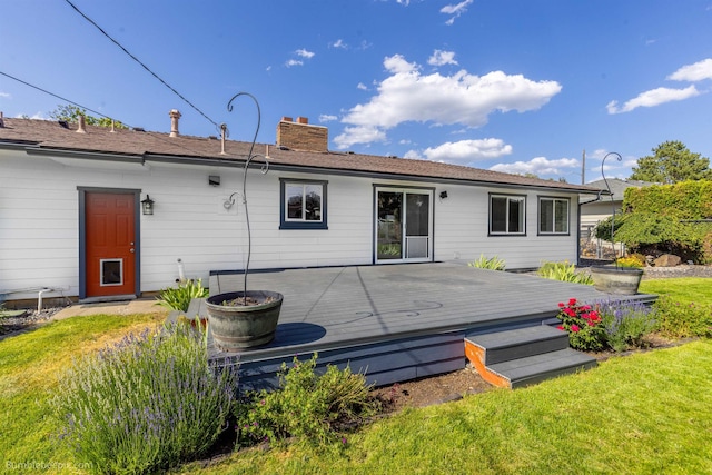 11918 E Grace Ave, Spokane Valley, WA 99206 - rear view of house featuring a chimney, a deck, and a lawn