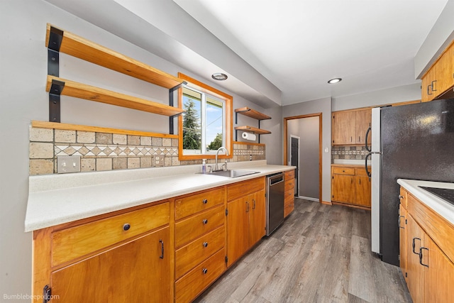 11918 E Grace Ave, Spokane Valley, WA 99206 - kitchen with stainless steel appliances, open shelves, light wood-style floors, tasteful backsplash, and light countertops