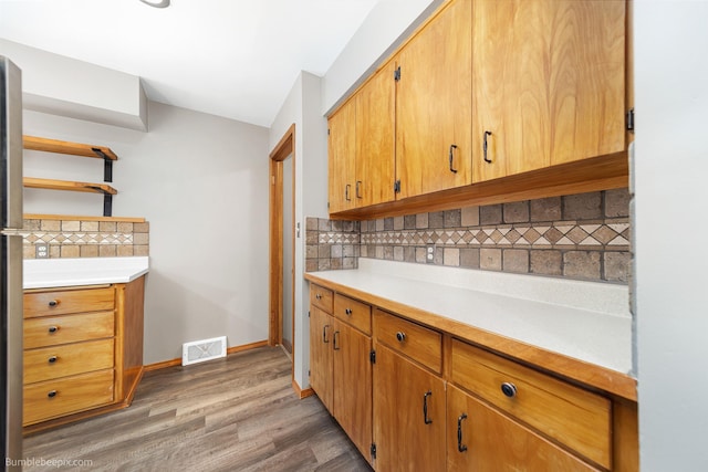 11918 E Grace Ave, Spokane Valley, WA 99206 - kitchen with open shelves, backsplash, wood finished floors, light countertops, and lofted ceiling