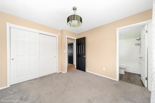 11918 E Grace Ave, Spokane Valley, WA 99206 - unfurnished bedroom with a closet, carpet flooring, ensuite bath, and a chandelier