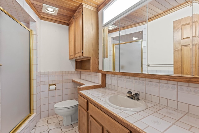 214 W 6th Ave Apt 201, Spokane, WA 99204 - bathroom with a shower stall, wood ceiling, vanity, tile walls, and a wainscoted wall