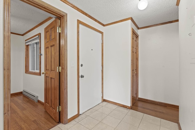 214 W 6th Ave Apt 201, Spokane, WA 99204 - corridor with a textured ceiling, ornamental molding, a baseboard radiator, and light tile patterned floors