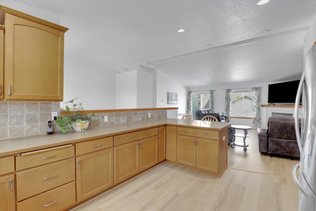 1707 E Vanetta Ave, Spokane, WA 99217 - kitchen with open floor plan, a peninsula, light countertops, light wood finished floors, and decorative backsplash