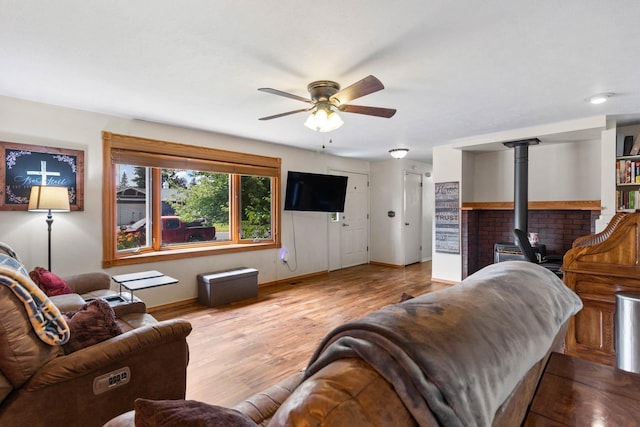 6204 N Oxford Dr, Spokane, WA 99208 - living room with ceiling fan, a wood stove, and wood finished floors