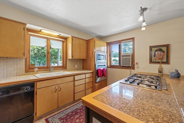 3157 E 35th Ave, Spokane, WA 99223 - kitchen with appliances with stainless steel finishes, backsplash, tile countertops, and a textured ceiling