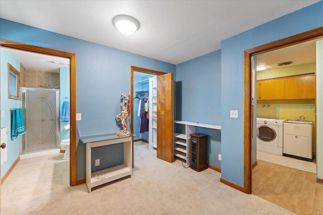 3157 E 35th Ave, Spokane, WA 99223 - bedroom with washing machine and clothes dryer, a walk in closet, a closet, and carpet floors