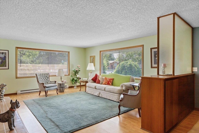 3157 E 35th Ave, Spokane, WA 99223 - living area with plenty of natural light, wood finished floors, a baseboard radiator, and a textured ceiling