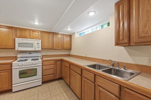 3157 E 35th Ave, Spokane, WA 99223 - kitchen with white appliances, light countertops, brown cabinetry, and recessed lighting