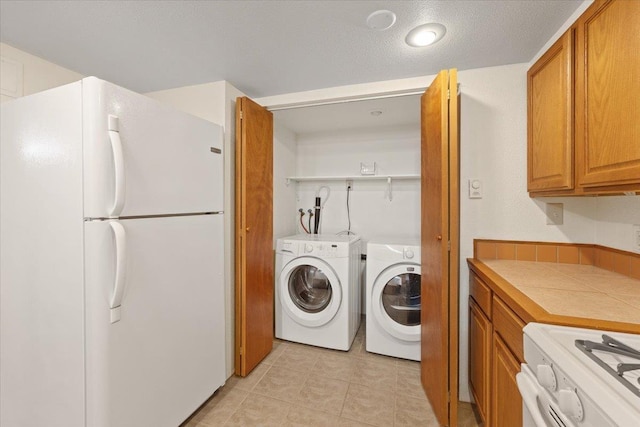 3157 E 35th Ave, Spokane, WA 99223 - laundry room with light tile patterned floors and washing machine and clothes dryer