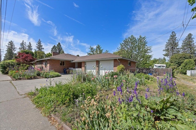 3157 E 35th Ave, Spokane, WA 99223 - view of front facade with brick siding, an attached garage, and a chimney