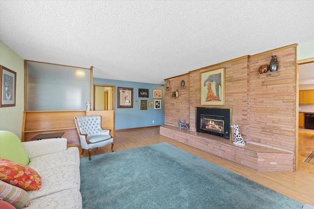 3157 E 35th Ave, Spokane, WA 99223 - living room with wood finished floors, a glass covered fireplace, and a textured ceiling