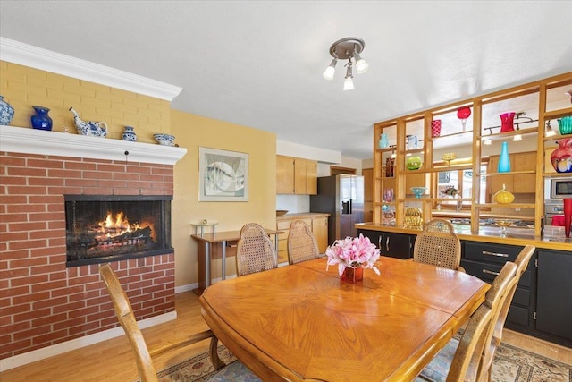 3157 E 35th Ave, Spokane, WA 99223 - dining room with light wood-type flooring and a fireplace