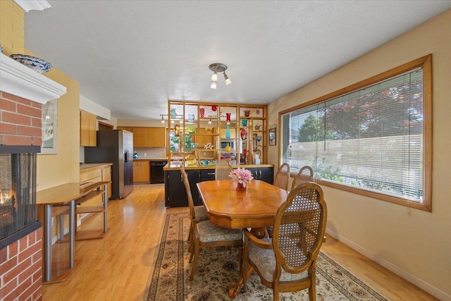 3157 E 35th Ave, Spokane, WA 99223 - dining room with light wood-type flooring and a fireplace