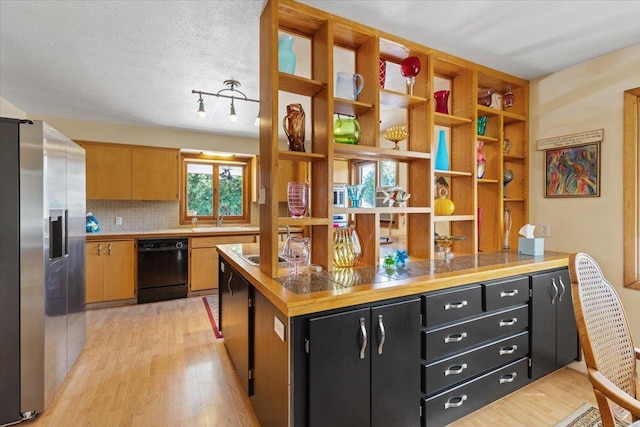 3157 E 35th Ave, Spokane, WA 99223 - kitchen with dishwasher, stainless steel refrigerator with ice dispenser, dark cabinets, and light wood-type flooring
