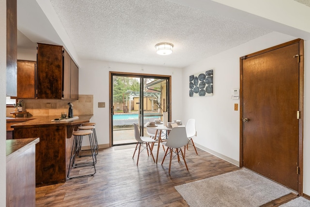 10818 N Humboldt Dr, Spokane, WA 99218 - dining space featuring wood finished floors and a textured ceiling