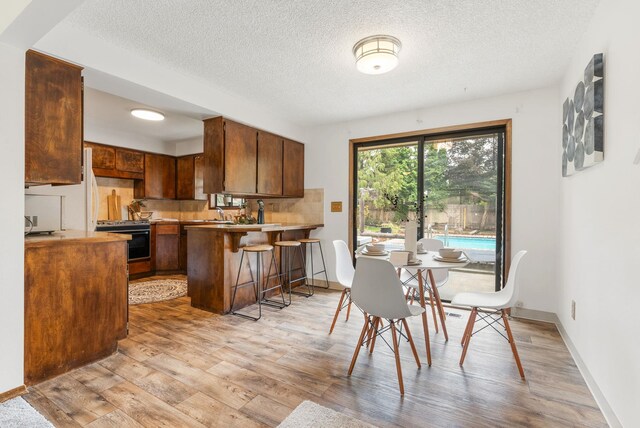 10818 N Humboldt Dr, Spokane, WA 99218 - dining room featuring light wood-style flooring and a textured ceiling