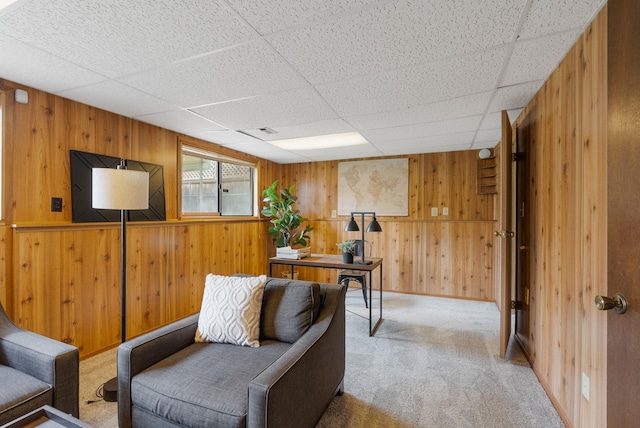 10818 N Humboldt Dr, Spokane, WA 99218 - living area featuring carpet, wood walls, and a drop ceiling