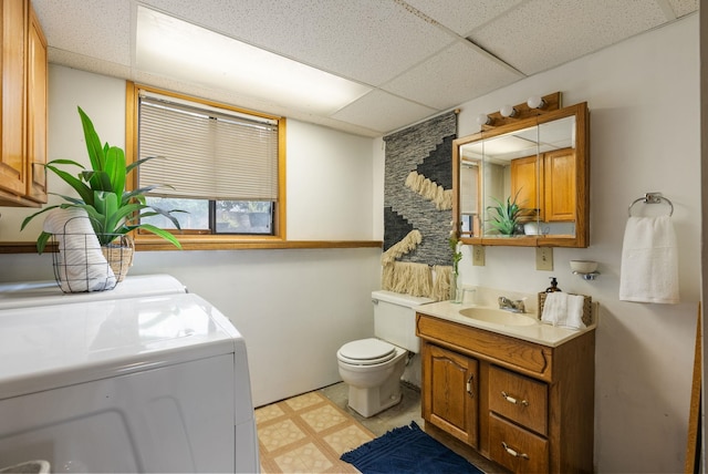 10818 N Humboldt Dr, Spokane, WA 99218 - bathroom featuring a paneled ceiling, separate washer and dryer, vanity, and tile patterned floors