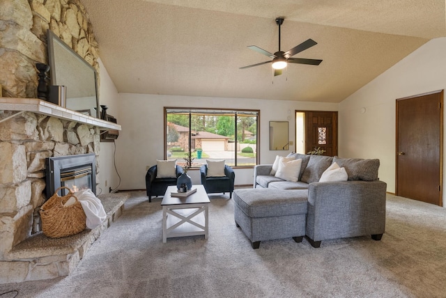10818 N Humboldt Dr, Spokane, WA 99218 - living room featuring lofted ceiling, carpet floors, a ceiling fan, a stone fireplace, and a textured ceiling