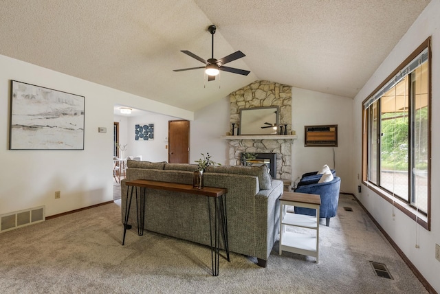 10818 N Humboldt Dr, Spokane, WA 99218 - carpeted living area with ceiling fan, a fireplace, vaulted ceiling, and a textured ceiling
