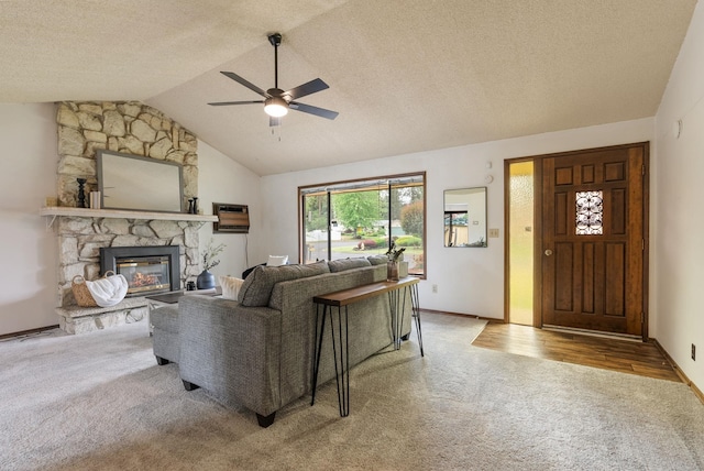 10818 N Humboldt Dr, Spokane, WA 99218 - living room with carpet flooring, ceiling fan, vaulted ceiling, and a stone fireplace
