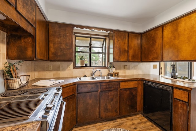 10818 N Humboldt Dr, Spokane, WA 99218 - kitchen with black dishwasher, stove, tasteful backsplash, wood finished floors, and a peninsula