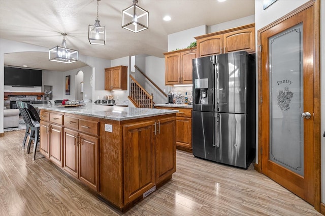 2813 S Steen Ln, Greenacres, WA 99016 - kitchen featuring stainless steel fridge, arched walkways, light wood finished floors, open floor plan, and recessed lighting