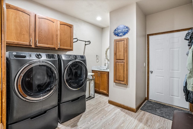 2813 S Steen Ln, Greenacres, WA 99016 - washroom featuring cabinet space, washer and clothes dryer, light wood finished floors, and recessed lighting
