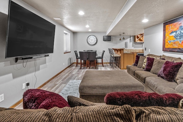 2813 S Steen Ln, Greenacres, WA 99016 - living room with wet bar, a textured ceiling, light wood-style flooring, and recessed lighting
