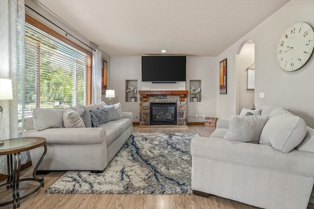 2813 S Steen Ln, Greenacres, WA 99016 - living room with plenty of natural light, arched walkways, wood finished floors, and a fireplace