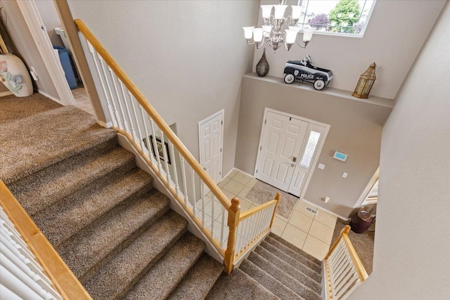 9713 W Sage Ct, Cheney, WA 99004 - tiled entrance foyer with stairway, a chandelier, and a towering ceiling