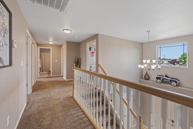 9713 W Sage Ct, Cheney, WA 99004 - hall featuring an upstairs landing, a chandelier, and carpet floors
