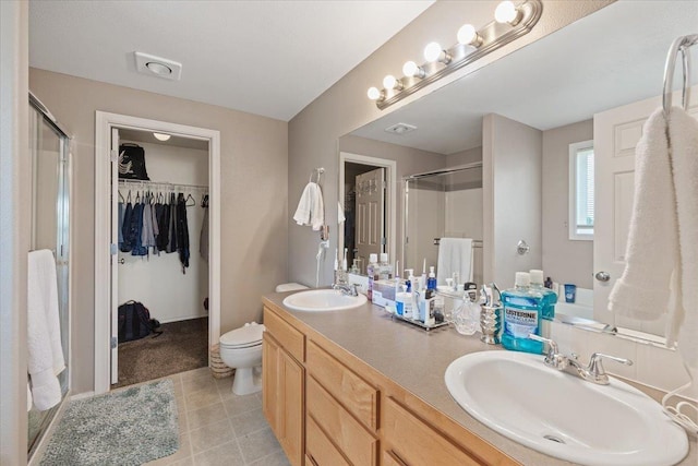 9713 W Sage Ct, Cheney, WA 99004 - full bathroom featuring a shower stall, double vanity, and a walk in closet