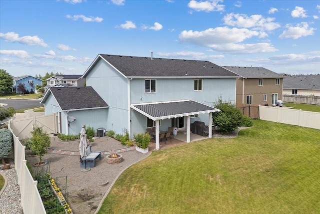9713 W Sage Ct, Cheney, WA 99004 - back of house with a patio area, a fenced backyard, a residential view, roof with shingles, and a metal roof