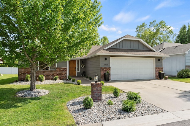 2808 E 62nd Ln, Spokane, WA 99223 - view of front of property featuring brick siding, an attached garage, concrete driveway, and board and batten siding