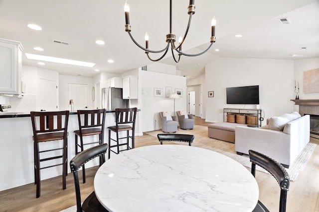 2808 E 62nd Ln, Spokane, WA 99223 - dining room featuring light wood-style floors, recessed lighting, lofted ceiling, and a chandelier
