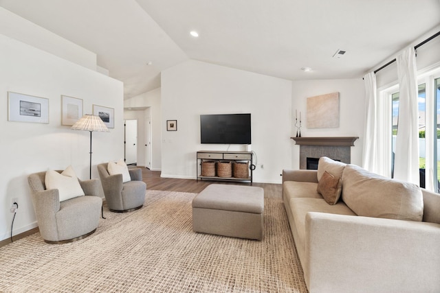 2808 E 62nd Ln, Spokane, WA 99223 - living room featuring wood finished floors, vaulted ceiling, a tiled fireplace, and recessed lighting