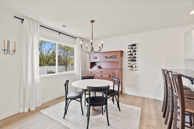 2808 E 62nd Ln, Spokane, WA 99223 - dining area featuring a chandelier and light wood finished floors