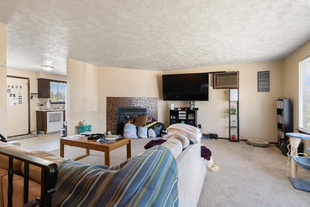 1526-1528 E Rowan Ave, Spokane, WA 99207 - living room with a textured ceiling, light colored carpet, an AC wall unit, and a fireplace